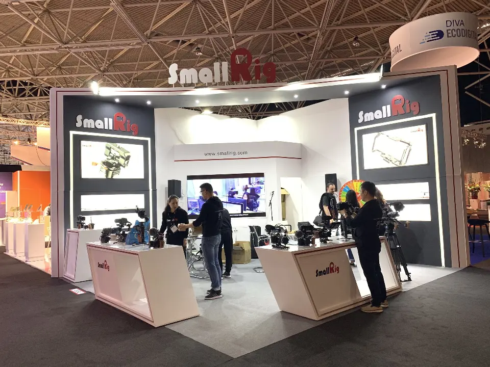 SmallRig booth with red logo header, angled white counters and camera rigs on display