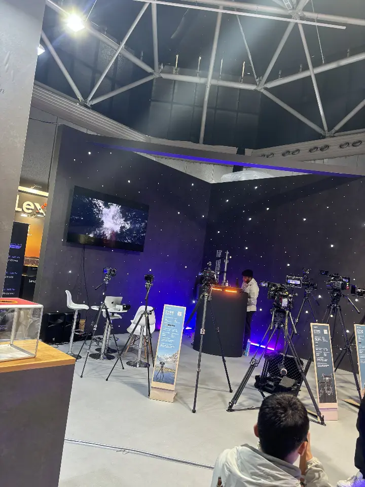 Display area with camera rigs and blue-lit platform edge