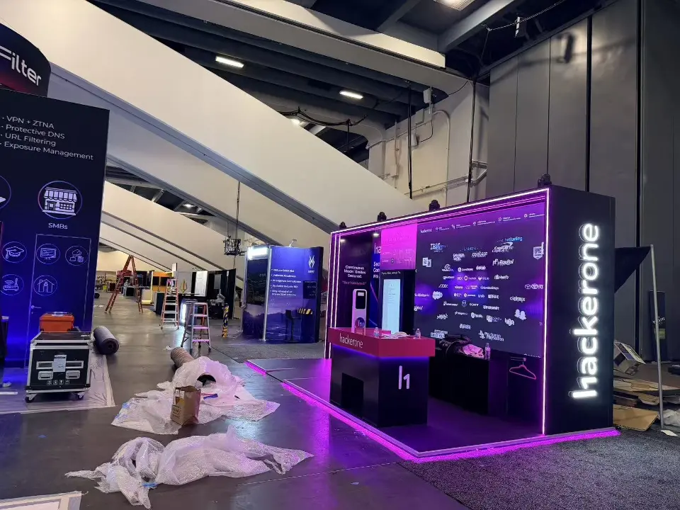 HackerOne corner with purple lit edges and packing still on the floor