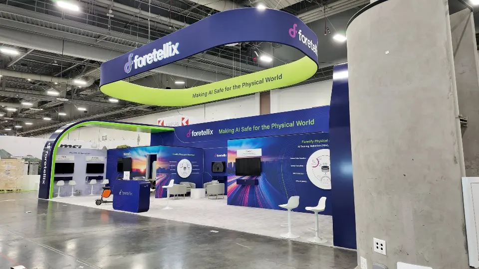 During installation: wide view of the finished booth walls in an empty hall