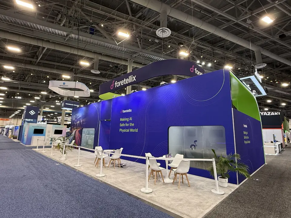 Back side of the booth seen from the aisle with cafe seating
