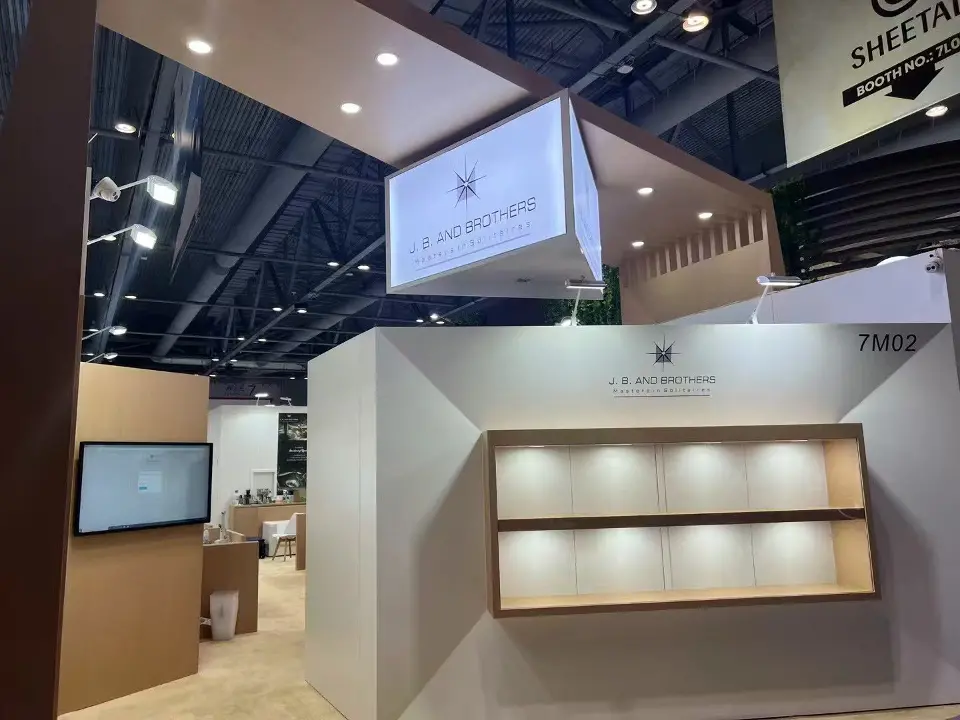J.B. and Brothers booth with white display front, lit wood-look shelves and hanging box