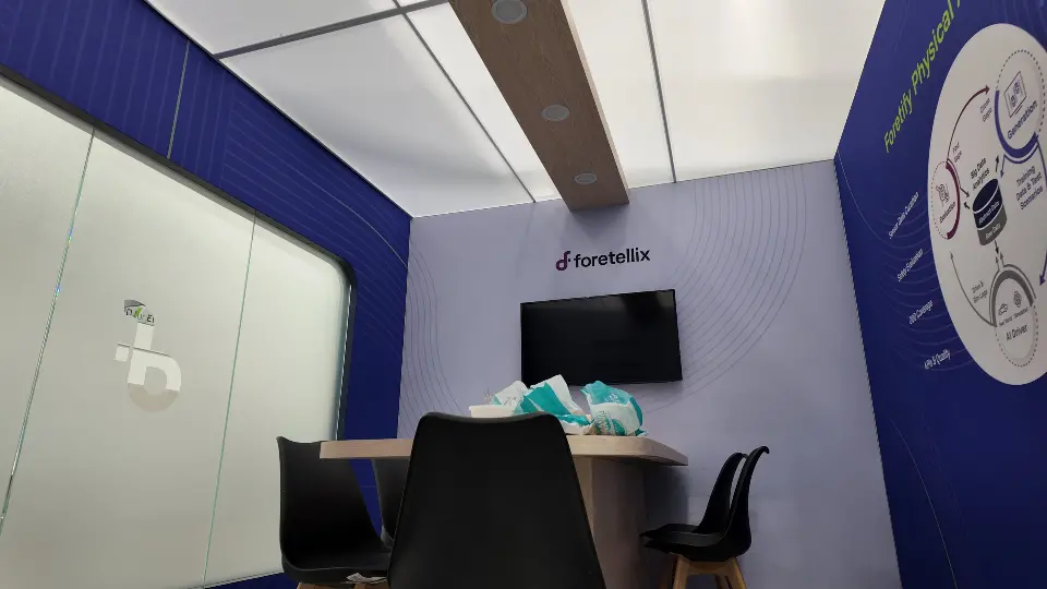 Meeting room interior with wall screen, table and frosted glass