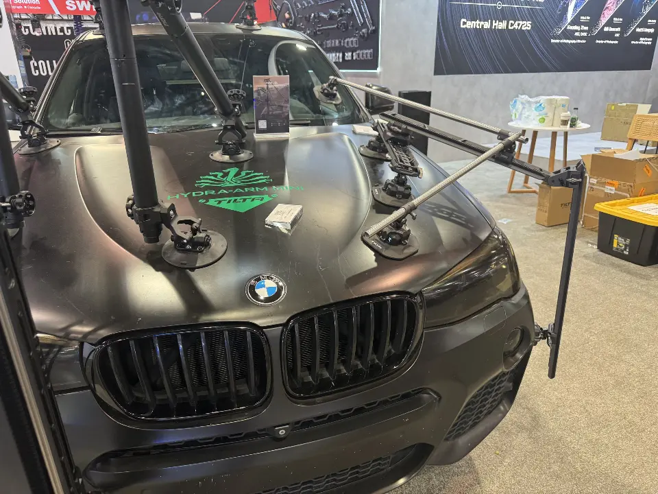 Close-up of the SUV hood with suction-mount camera rig arms