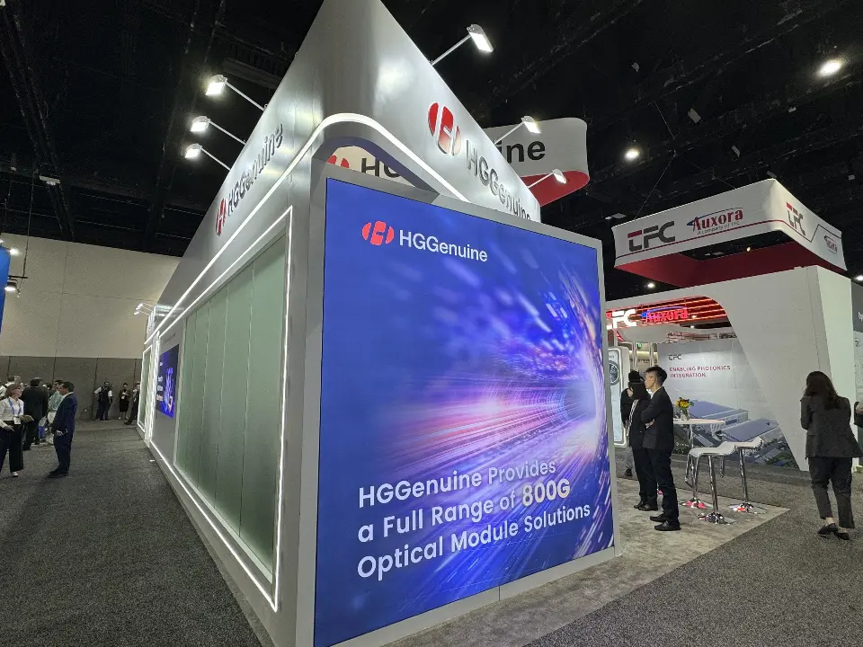 Corner of the booth with a blue optical module graphic and frosted glass panel