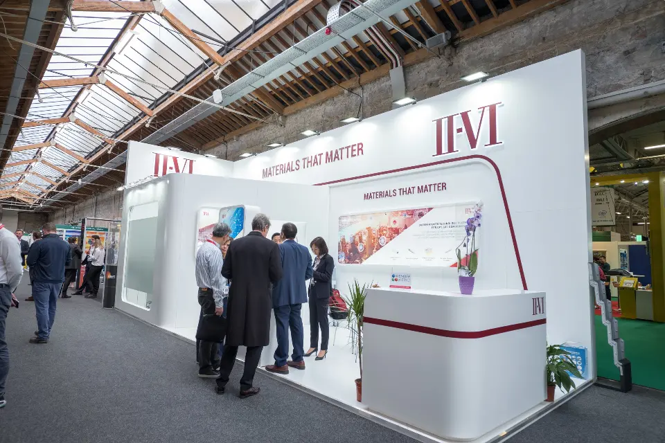 Crowd gathered near the counter with the Materials That Matter tagline overhead