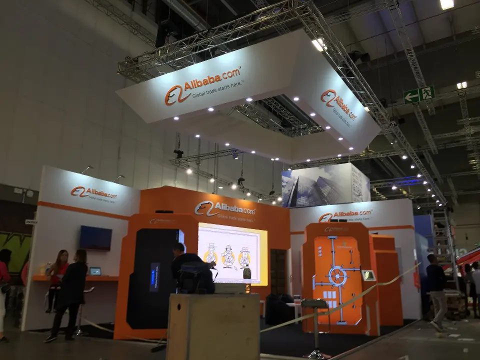 Visitors near the backlit panel and orange device-shaped screen frames