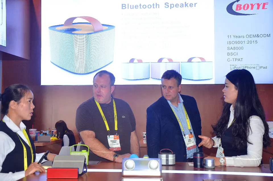 Close view of staff demonstrating speakers on the front counter