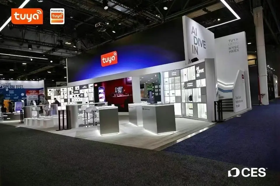 Wide view of the Tuya booth with product walls and a pink-lit screen