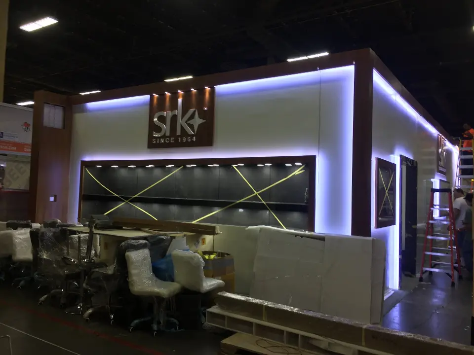 Front corner showing the showcase, kiosk stand and lit edge strips