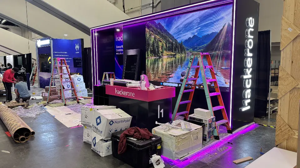 Back wall with a scenic graphic, ladders and boxes during set-up