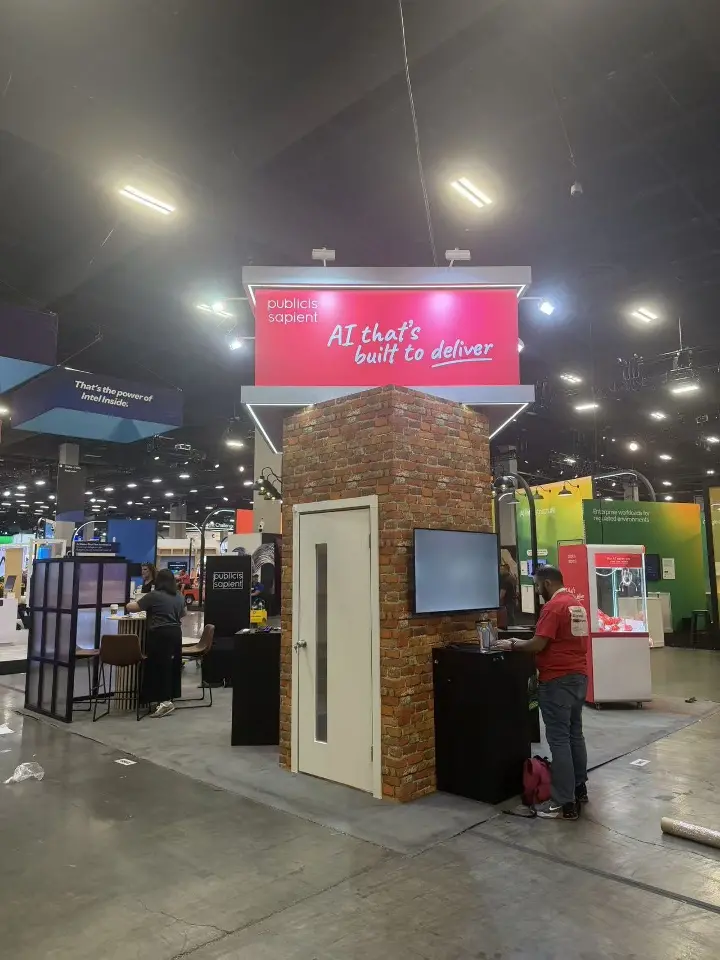 Brick-look tower with white door, side screen and the red AI that's built to deliver header