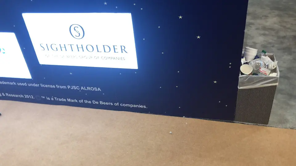 Close-up of a backlit Sightholder sign on the dark starry wall