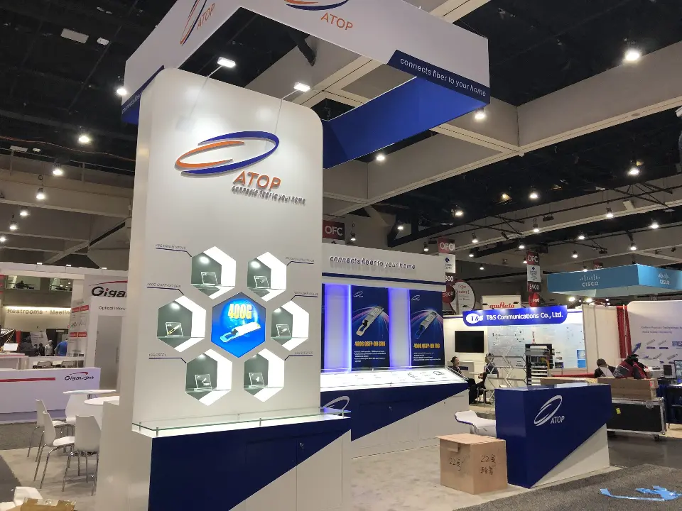 ATOP tower with lit hexagon showcase of transceivers and blue product wall behind