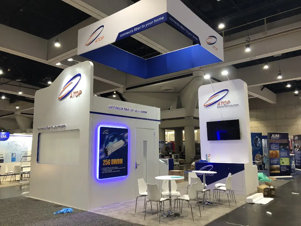 Wide view of the finished ATOP booth with hanging square sign and seating