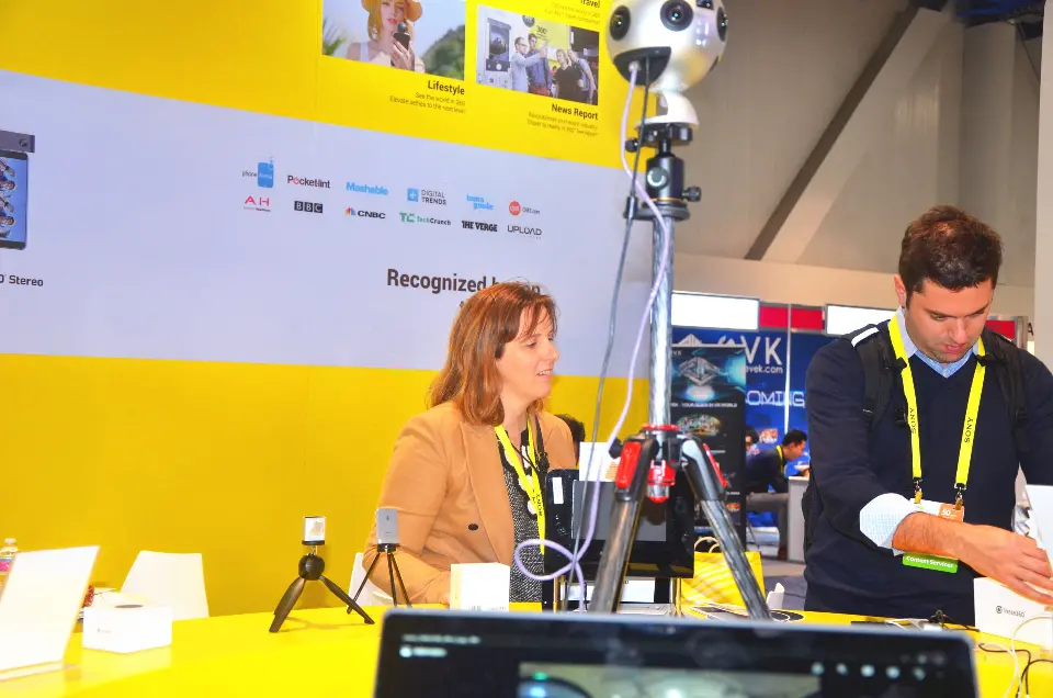 Staff and visitor at the yellow wall with a spherical camera rig on a tripod