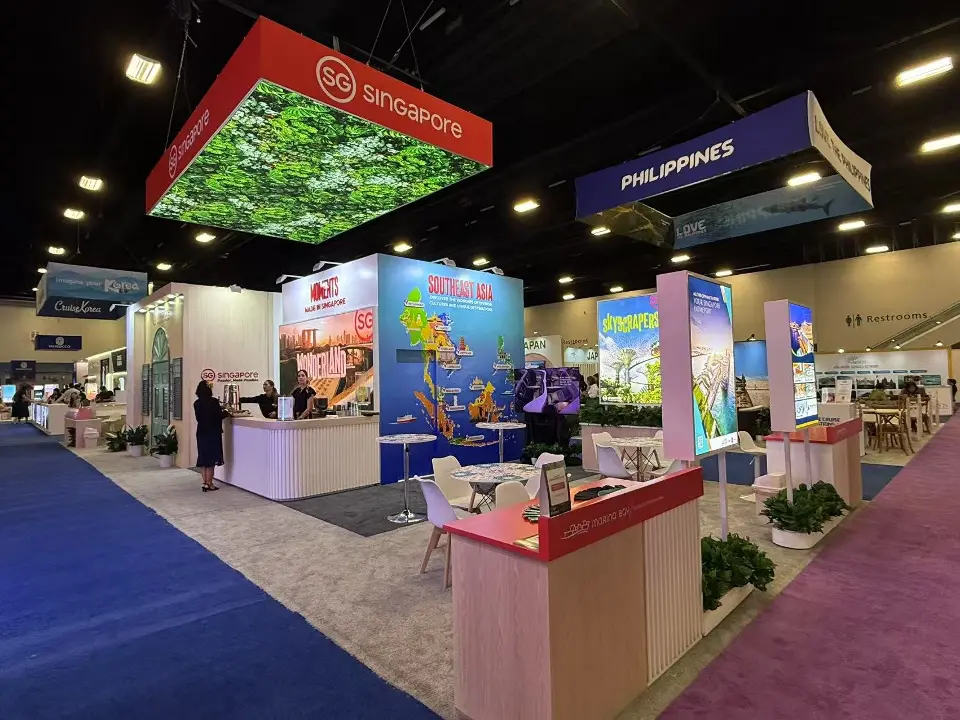 Stand overview with canopy, counters and backlit destination graphics