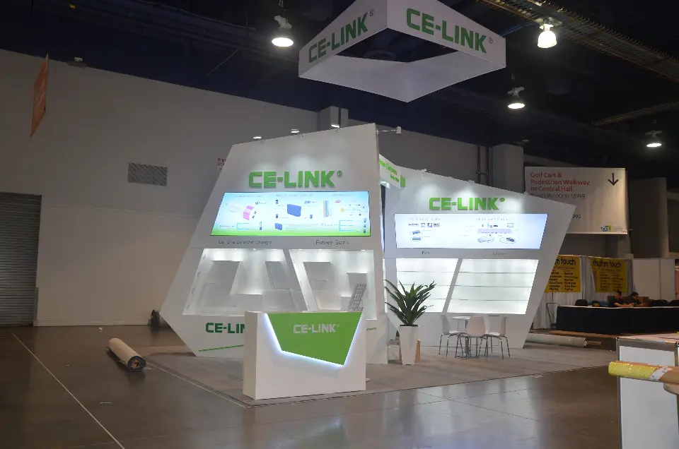 CE-LINK stand at CES 2017 with leaning white walls, green lettering and square hanging sign