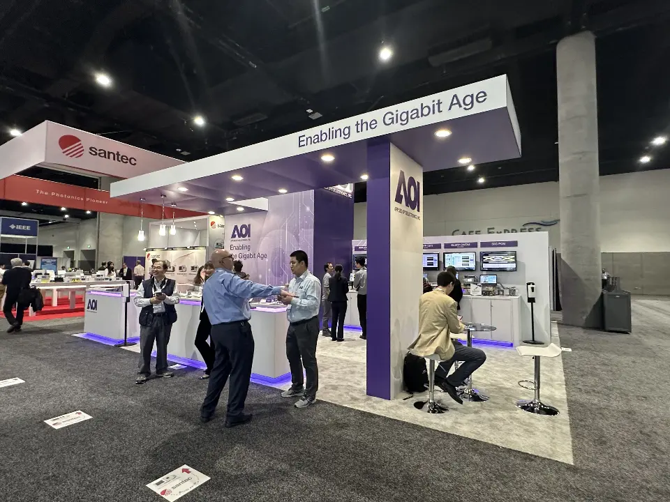 Booth corner with a purple column and the Enabling the Gigabit Age header