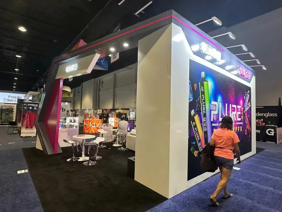 Side tower of the PLURE booth with a colorful backlit product graphic