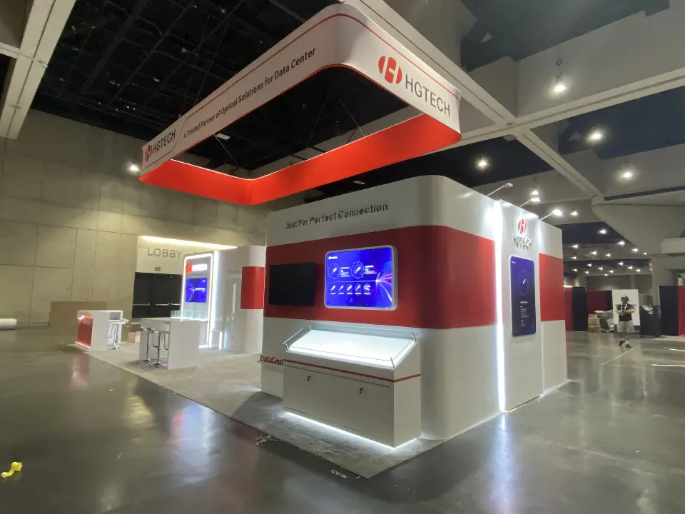 Booth corner with a lit tabletop display and white rounded walls
