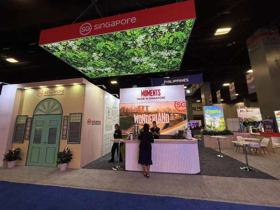 Red canopy above a backlit graphic wall and branded counter