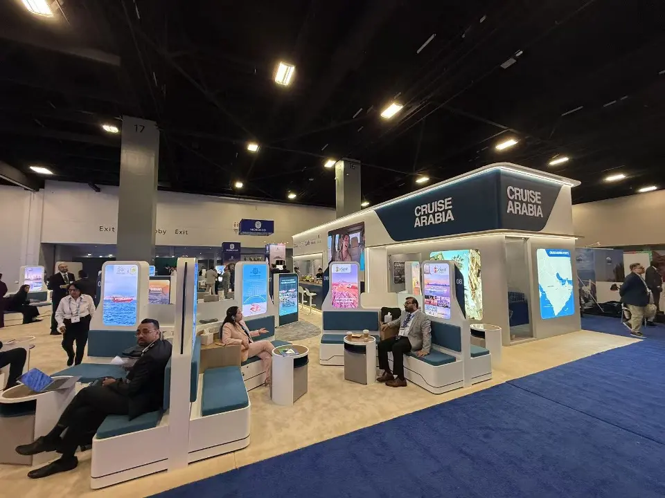 Corner view of the long booth with Cruise Arabia sign and seated guests