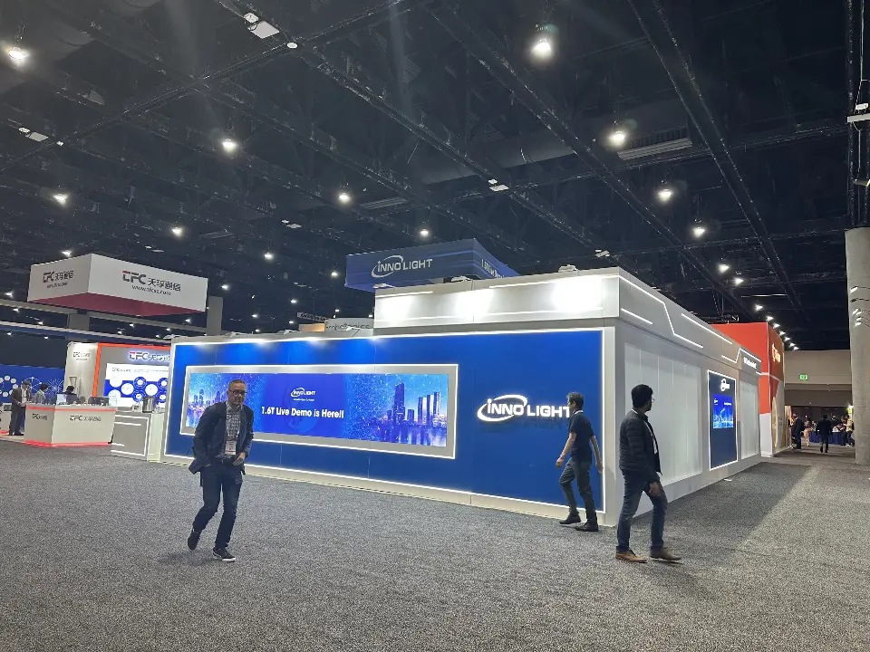 Wider view of the blue and white frosted walls with visitors passing