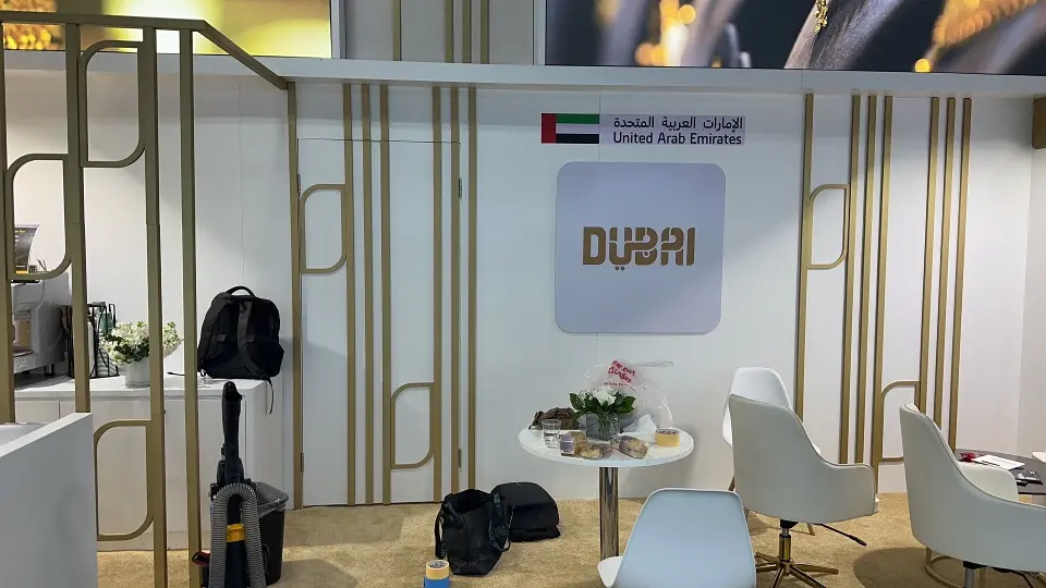 Back area with the DUBAI sign, round tables and white chairs