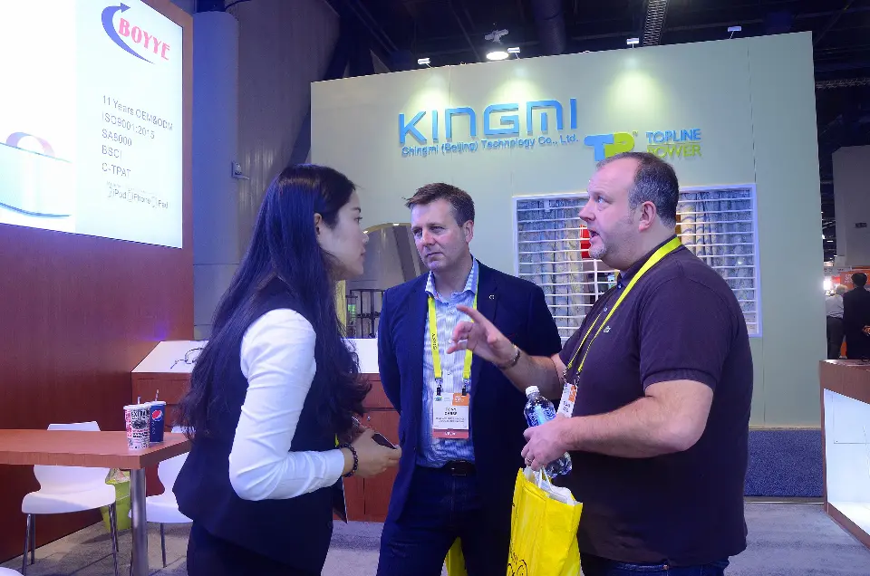 Group discussion at the booth with lightbox and shelving behind
