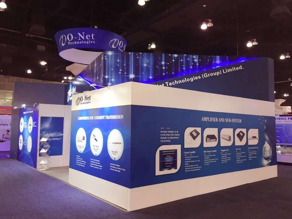 Long side of the booth with blue printed walls and the round sign above