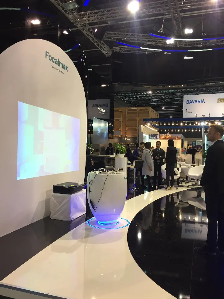 White projection wall and curved white counter edge beside the aisle