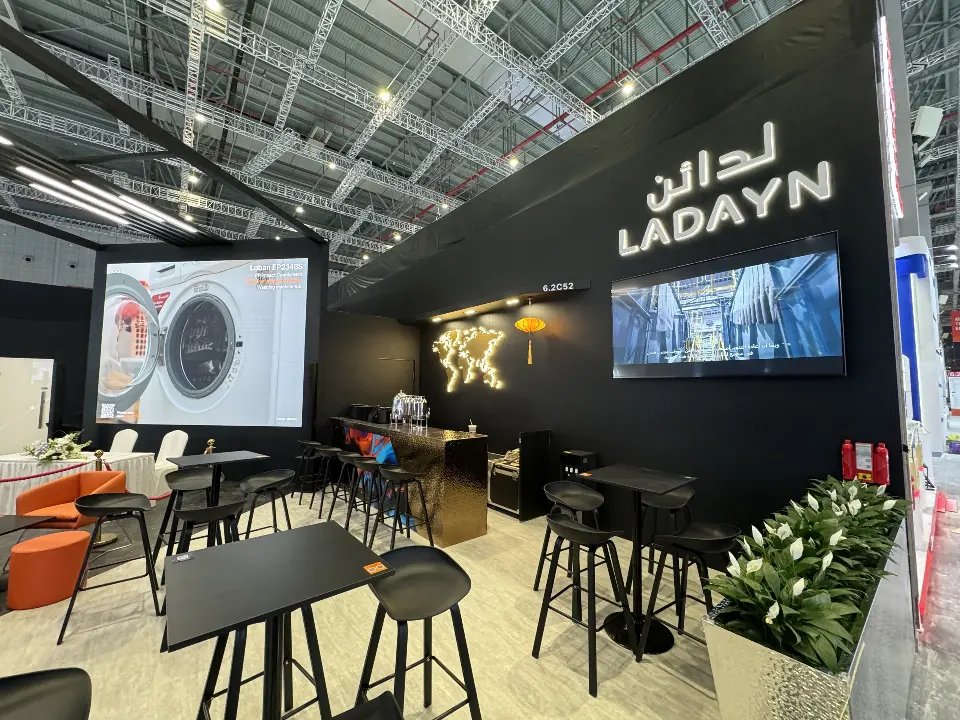 High tables and bar stools beneath LADAYN lettering and a large rear video screen