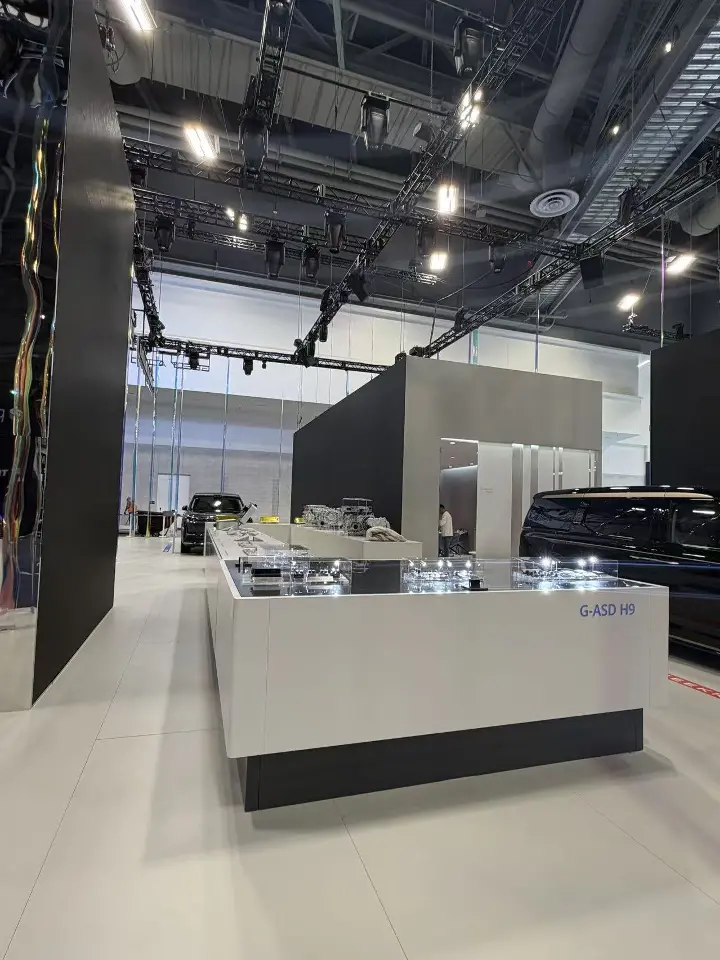 Portrait view of a white counter with a car display in the background