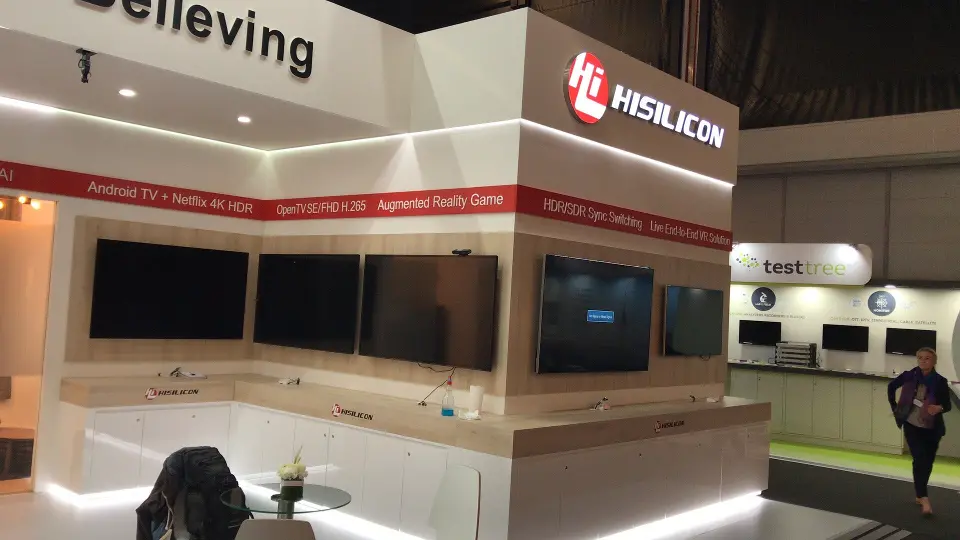 Corner of the HiSilicon booth with Seeing is Believing lettering and screens
