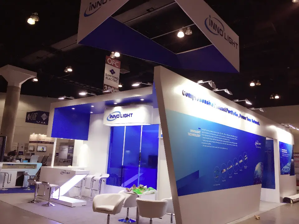 Long side of the booth with a blue glass wall and product text