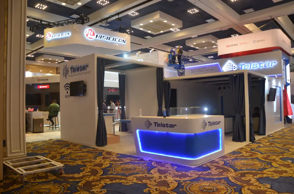 Front view with the blue-lit counter on ballroom carpet and hanging signs