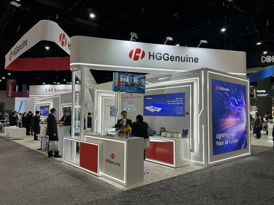 Open side of the booth with red reception counter, video screen and blue graphics