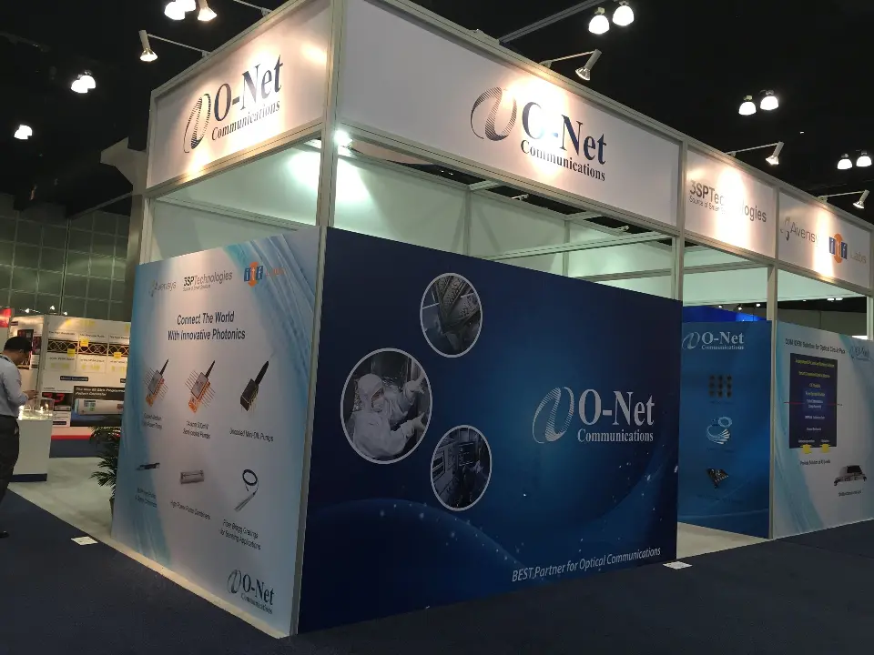 Corner of the booth with navy component graphics and white header