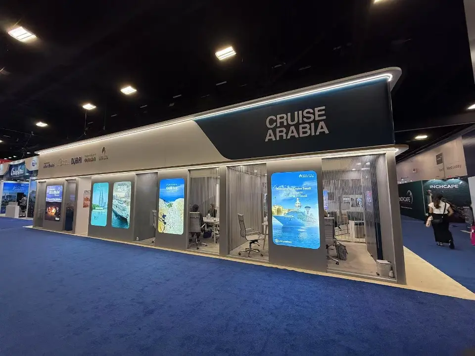 Long glass-front wall with backlit panels below the Cruise Arabia sign
