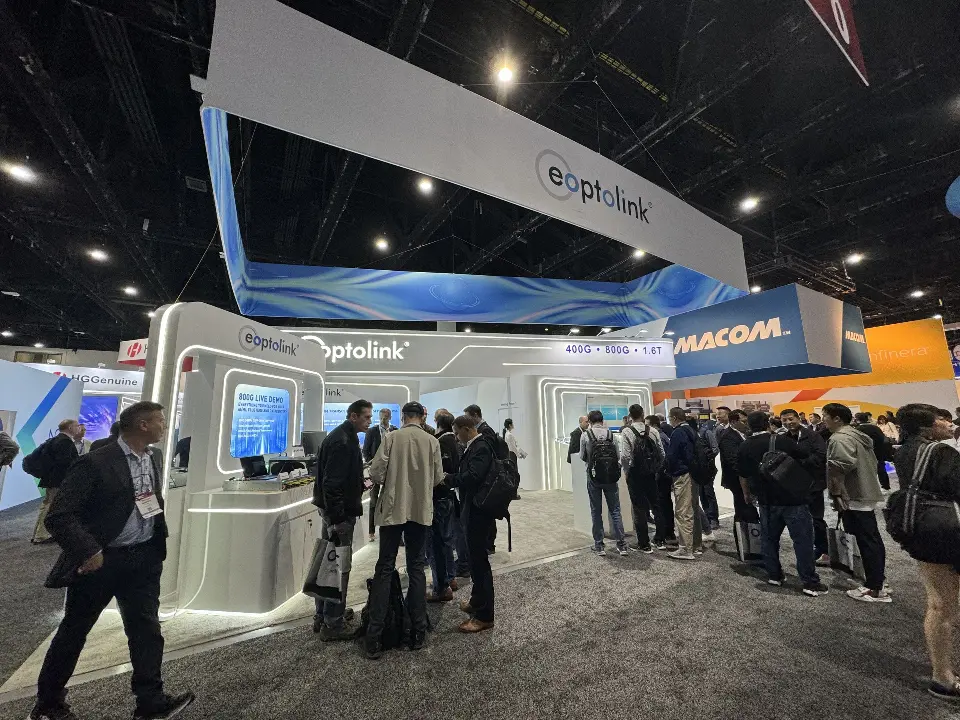 Visitors gathered beneath the raised header and white product walls