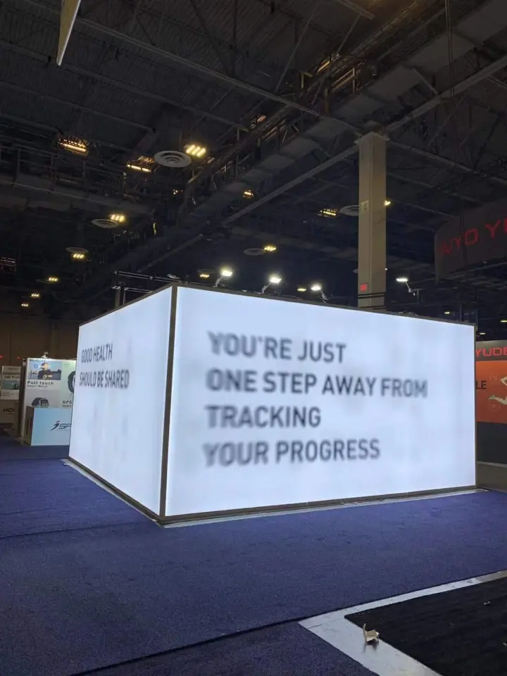 Portrait view of the large backlit wall with the tracking progress message