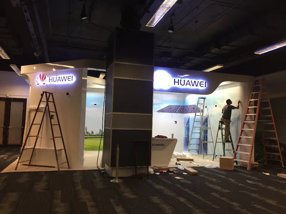 During installation: second view of the crew on ladders at the white Huawei walls