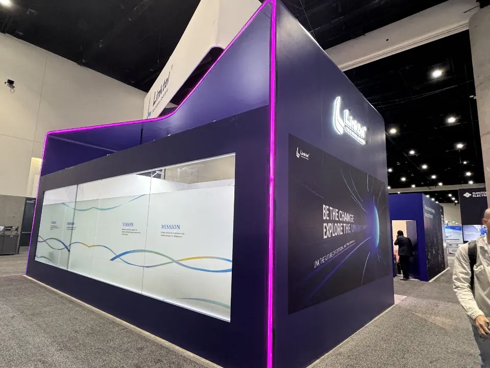 Frosted window panel with wave graphic along the side of the purple booth
