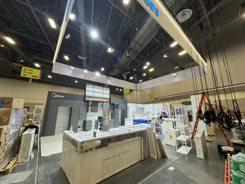 During installation: suspended white frame above a kitchen counter with crates around it