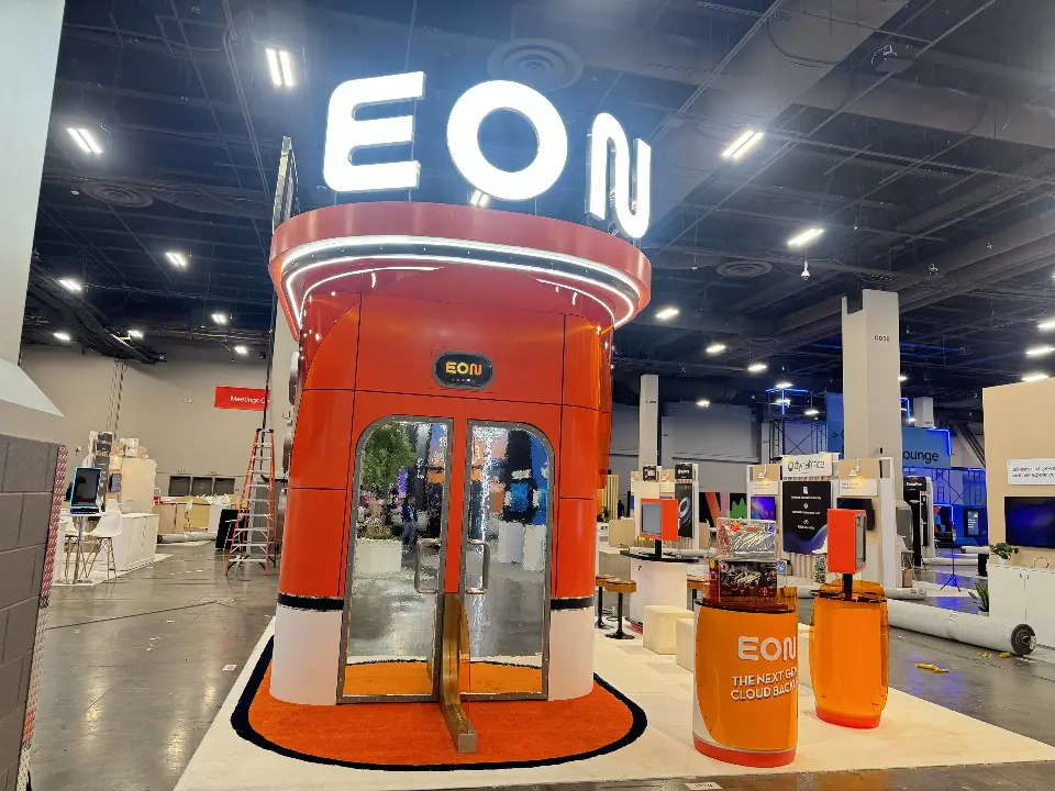 Orange entrance with a glass door and EON letters above