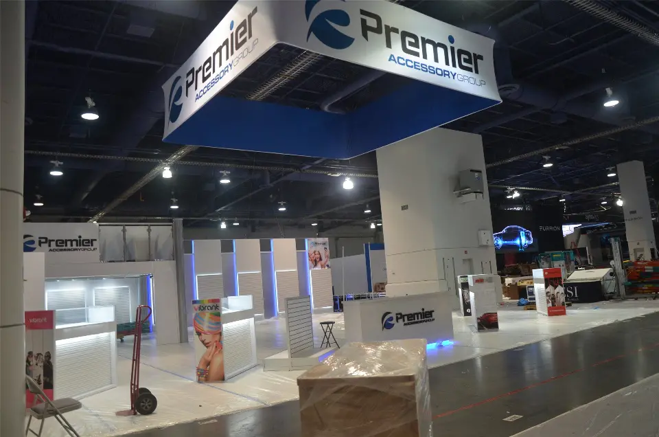 During installation: Premier Accessory hanging square sign above white display bays and a logo counter