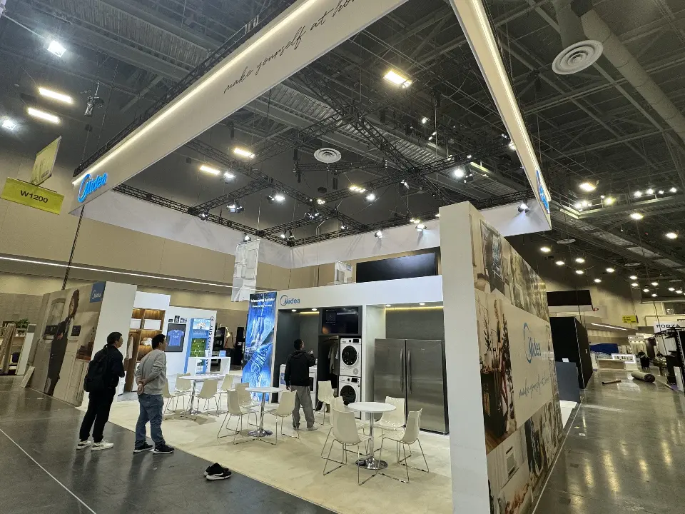 Wide view of the finished booth under the Midea frame with kitchen and lifestyle walls