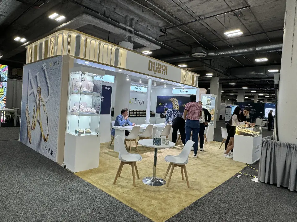 Wide view of several pavilion stands with white tables and showcases