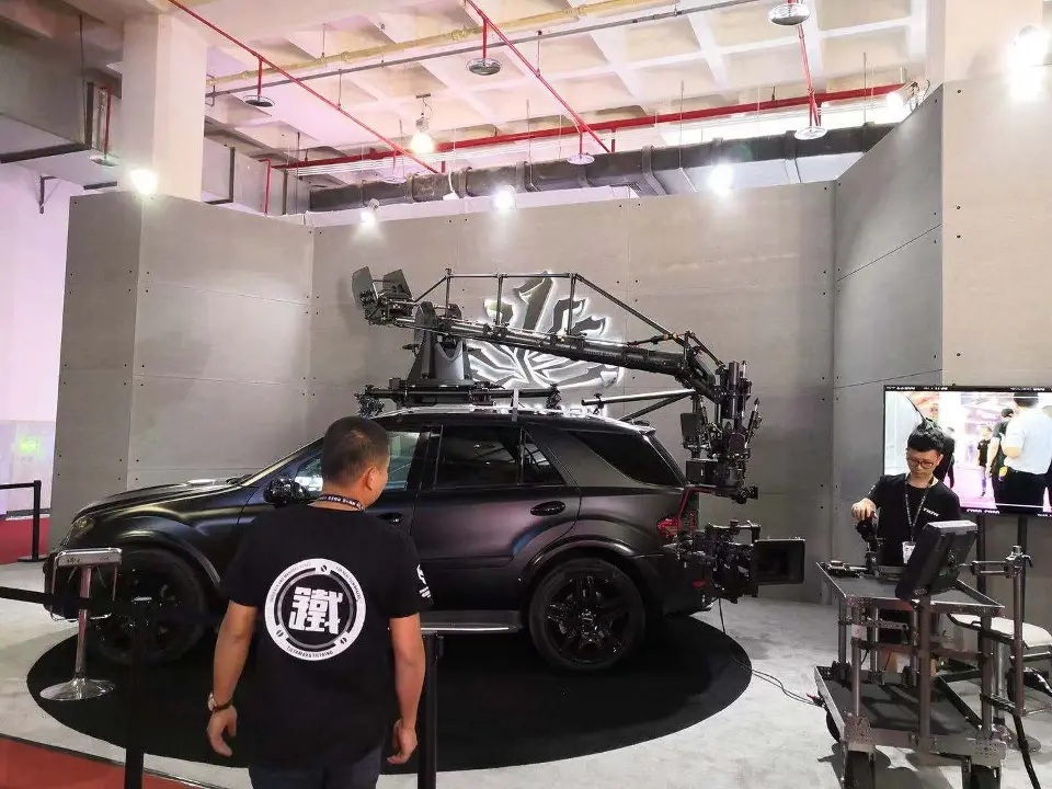 Close view of the car and crane arm with visitors in front